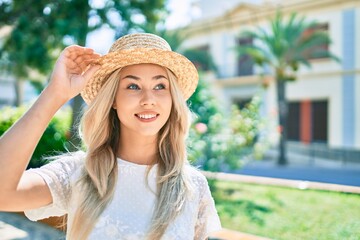 Young caucasian tourist girl smiling happy walking at street of city.