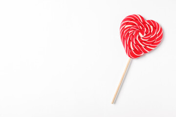Sweet heart shaped lollipop on white background, top view with space for text. Valentine's day...