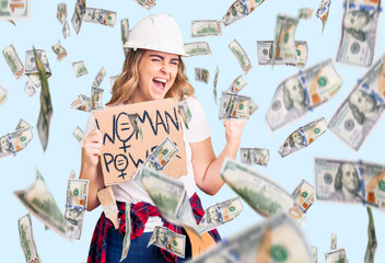 Young caucasian woman holding woman power banner screaming proud, celebrating victory and success very excited with raised arms