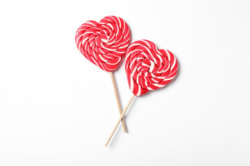 Sweet heart shaped lollipops on white background, flat lay. Valentine's day celebration
