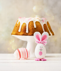 Happy Easter Festive background with Easter egg, cake and Easter bunny