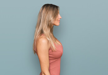 Fototapeta premium Beautiful caucasian woman wearing casual clothes looking to side, relax profile pose with natural face with confident smile.
