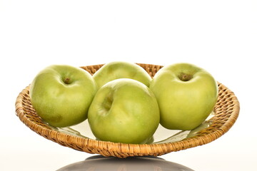 Several sweet green apples by Renet Simirenko with a ceramic plate, close-up, isolated on white.