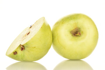 One half green apple of Renet Simirenko and one whole apple, close-up, isolated on white.