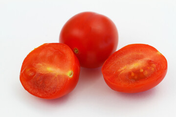 Cross section of cherry tomatoes on white background, closeup
