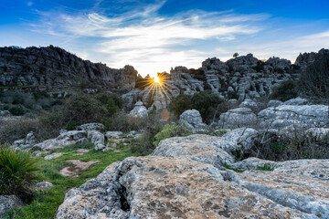 evening light with a sun star in the El Torcal Nature Reserve in Andalusia with strange karst rock formations