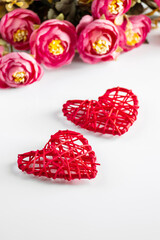 Flowers and red hearts on a white background for Valentine's Day