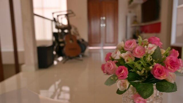 Video of lovely pink and white rose indoor decoration on glass vase. Taken from digital camera using  trucking left movement technique