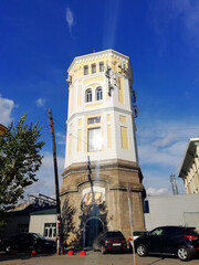 Fototapeta premium Yekaterinburg, Russia - 20.09.2020: Old water tower. Building with craquelures on yellow colour. 