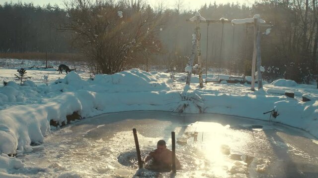 man steamed in a bath in the hot water outdoors