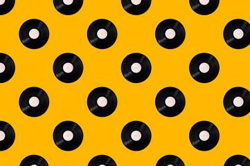 Pattern of vinyl records on a yellow background. Minimal trendy composition