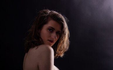 Sexy young woman close portrait on dark