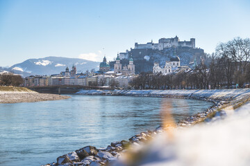 Naklejka premium City of Salzburg and snow river bank of Salzach, winter time.