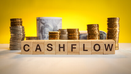Cashflow wording with coins and money in background. Business concept. Accounting concept.