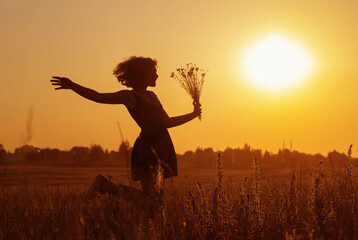 beautiful teenager girl in summer field with cornflower.