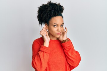 Young african american girl wearing casual clothes covering ears with fingers with annoyed expression for the noise of loud music. deaf concept.