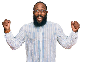 Young african american man wearing business shirt and glasses screaming proud, celebrating victory...