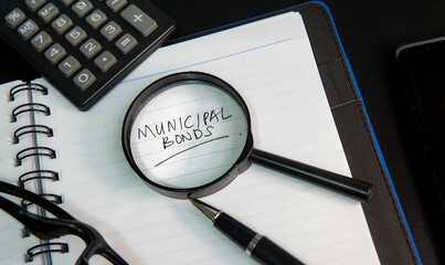 Municipal bond written on a book and documents.