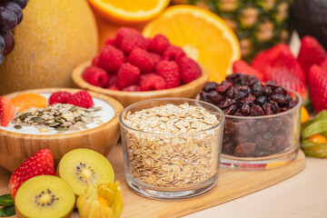 Group Fruits mixed with banana, orange, strawberry and nuts, concept health food and diet, vegetarian food in the top view on the wood table.