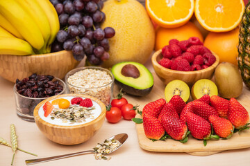 Fototapeta na wymiar Group Fruits mixed with banana, orange, strawberry and nuts, concept health food and diet, vegetarian food in the top view on the wood table.