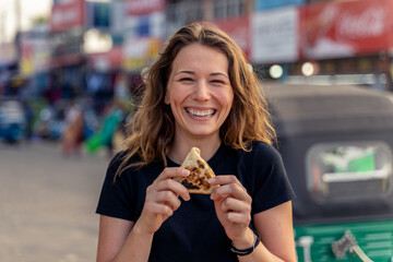 traveler eats vegetable roti in Sri Lankan street foot