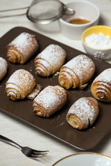 Delicious spiral cookies with sugar on a tray