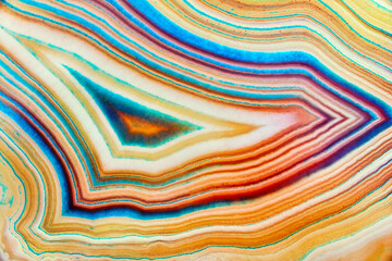 Amazing detailed and colorful cross section structure of banded yellow agate. Seamless crystal agate surface macro closeup. Marbled pattern mineral texture abstract background