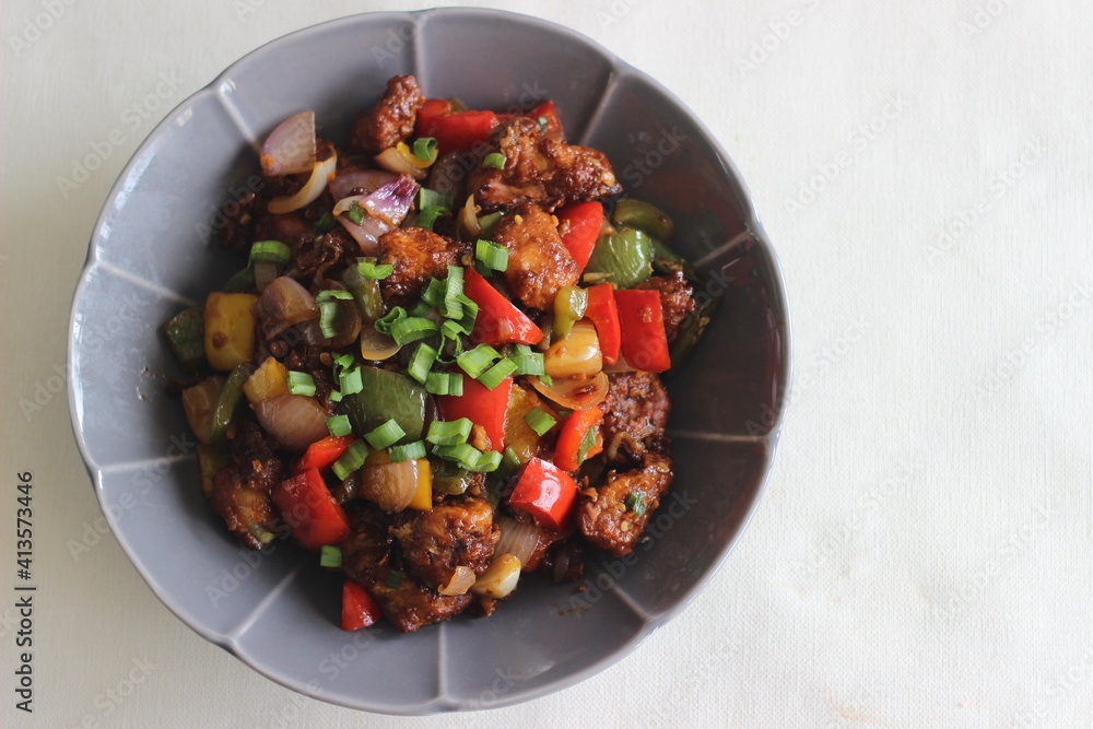 Wall mural chilli chicken is a sweet, spicy and slightly sour crispy appetizer made with chicken, bell peppers,