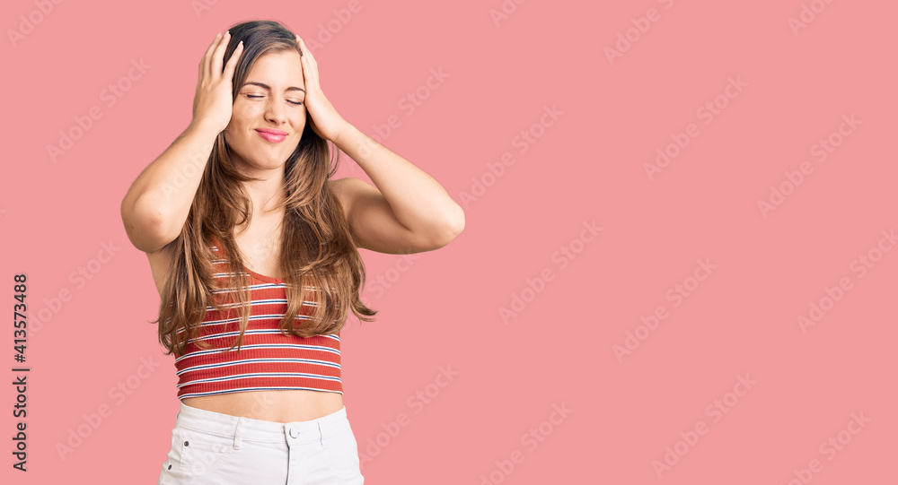 Wall mural Beautiful caucasian young woman wearing casual clothes suffering from headache desperate and stressed because pain and migraine. hands on head.