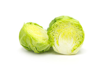 Fresh organic brussels sprouts halves isolated on white background.