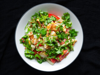 Spicy Fried Egg Salad Street food menu popularly eaten by Thais The main ingredients are eggs, coriander, tomatoes, onions, sour, salty. You can find it in the street food stalls.