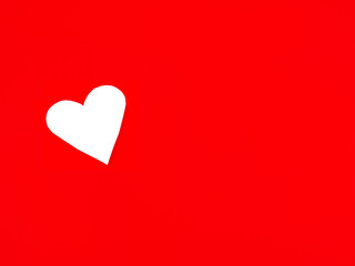 White paper hearts placed on a red background