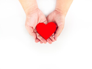 Fototapeta premium A red heart wrapped on both hands On a white background
