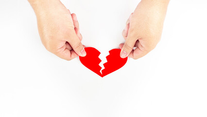 Obraz premium Both hands picked up the red heart pieces. That is split into two