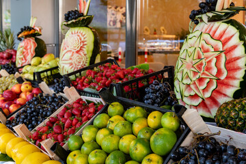 Open buffet full of delicious fruits with orange, grape, watermelon