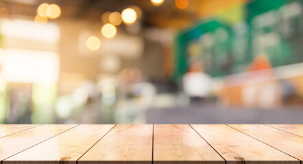 Empty wooden table top with lights bokeh on blur restaurant background