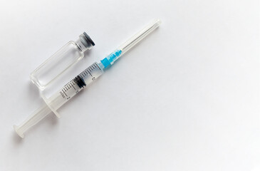 One medical glass bottle with syringe. a medical disposable syringe with a needle. Medical concept shows a medical test tube and vaccines against coronavirus. Copy place. High quality photo