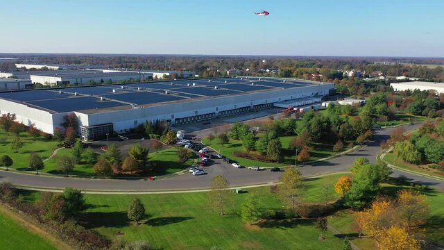 View of a Heavy Lift Helicopter Carrying an Old AC from Rooftop to the Ground