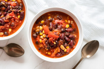 Vegetable Chili Bean Stew With Red Kidney Beans, Tomatoes, Sweetcorn, Red and Yellow Peppers On Flat Lay - 413582665