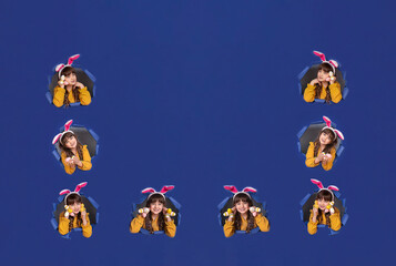 Spring season concept. Closeup photo portrait of positive glad nice pretty beautiful fashionable small lady demonstrating collection of colorful bright easter eggs in palms blue  background