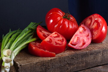 Fresh juicy vegetables tomatoes, parsley, onion ingredients for salad cooking, vegetarian dishes