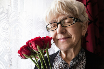 senior woman with red roses