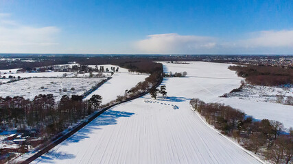 A birds eye view of the snow covered landscape in a rural part of Suffolk, UK