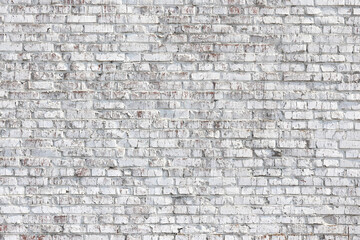 Beautiful brick background with old bricks in white paint, whole bricks and cracked bricks