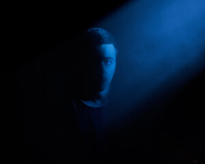 Portrait of a man looking at rays of light