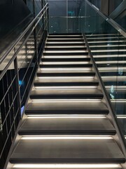 a modern stairway with lights going upstairs