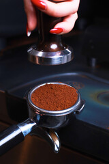 Close-up, coffee holder on the table, ground coffee beans in the filter, compacted coffee presses, blurred background