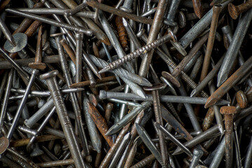 Macro view of a collection of old nails of various types and sizes.