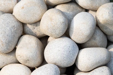 Fototapeta na wymiar Stacked White Colored Beautiful Decorative Stones Or Pebbles Suitable For Background Or Wallpaper