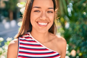 Fototapeta premium Young latin girl smiling happy walking at the city.